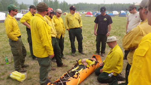 Crews receive training on assembling a field stretcher