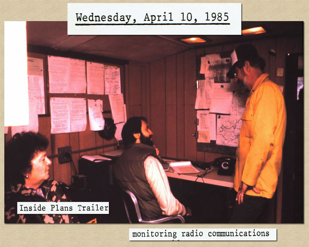 April 10, 1985: Photo of fire staff monitoring Radio Communications inside plans trailer.