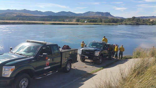 Strike team drawing water out of Holter Lake